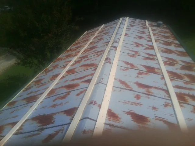 Rusted metal roof panels with new wood purlins before replacement — Storm Damage Roof Repair in Roosevelt by Roofing Brothers